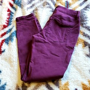 Maroon skinny jeans.